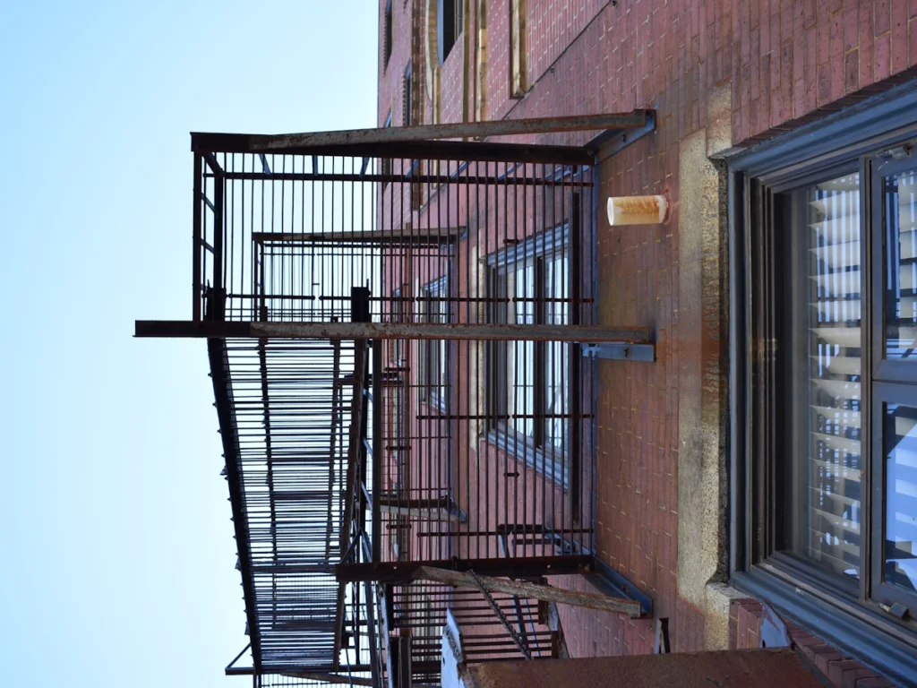 Black steel fire escape on a brick building after certification is filed with the local Westchester fire code official
