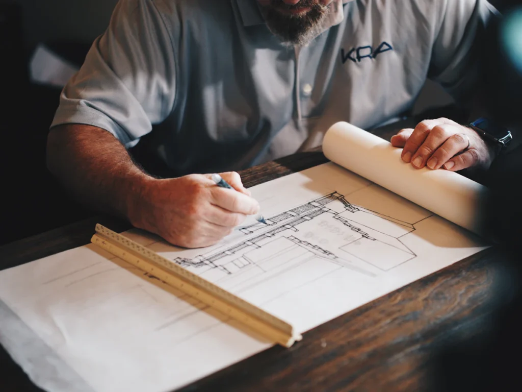 Engineer marking up construction drawings, the stamped design drawings prepared for a new fire escape installation in Westchester